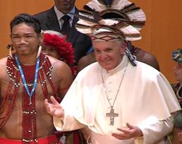 In this frame grab from video Pope Francis wears an indigenous feather hat given to him by representatives of one of Brazil's native tribes during a meeting at the Municipal Theater in Rio de Janeiro, Brazil, Saturday, July 27, 2013. Pope Francis is on the sixth day of his trip to Brazil where he will attend the 2013 World Youth Day in Rio. (AP Photo/TV Pool)